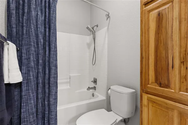 a bathroom with a toilet and shower