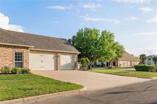 a front view of house with yard and green space
