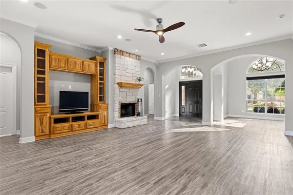an open kitchen view with fireplace and windows