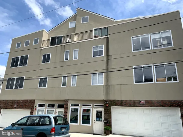 a front view of a building with parking space