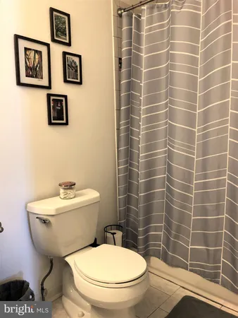 a white toilet sitting next to a bathroom sink