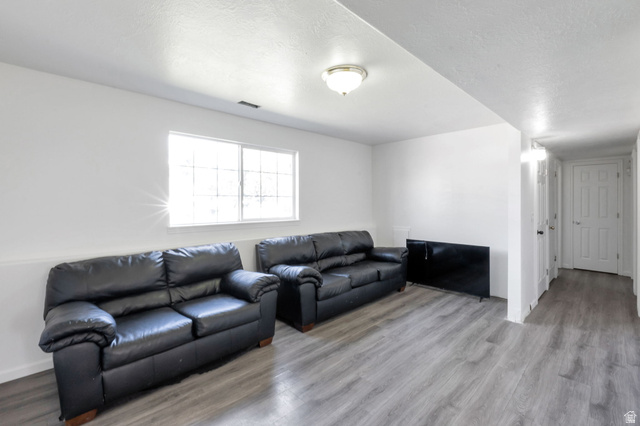 2013 West 460 South Provo, UT 84601 - Photo 17 of 24 Bright room featuring a window with grid patterns, recessed lighting, and wood-finish flooring