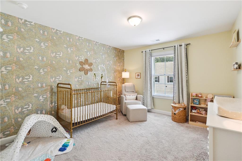 765 Trevett Way Marietta, GA 30066 - Photo 26 of 44 a bedroom with furniture and a lamp