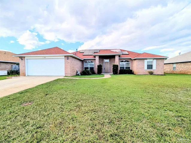 a view of a house with a big yard and large trees
