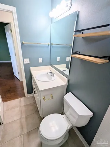 a white toilet sitting next to a bathroom sink
