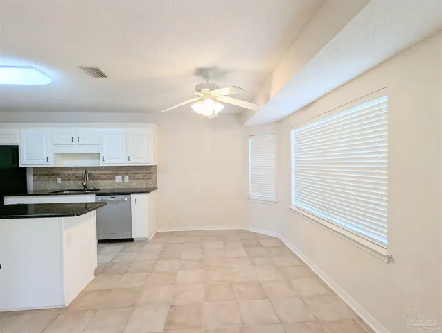 a kitchen with a sink cabinets and window