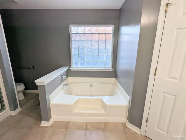 a bath tub sitting in a bathroom next to a window