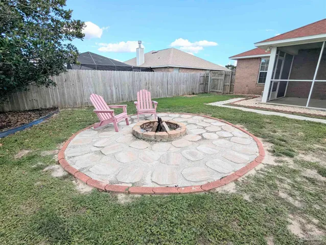 a view of a backyard with table and chairs with wooden fence