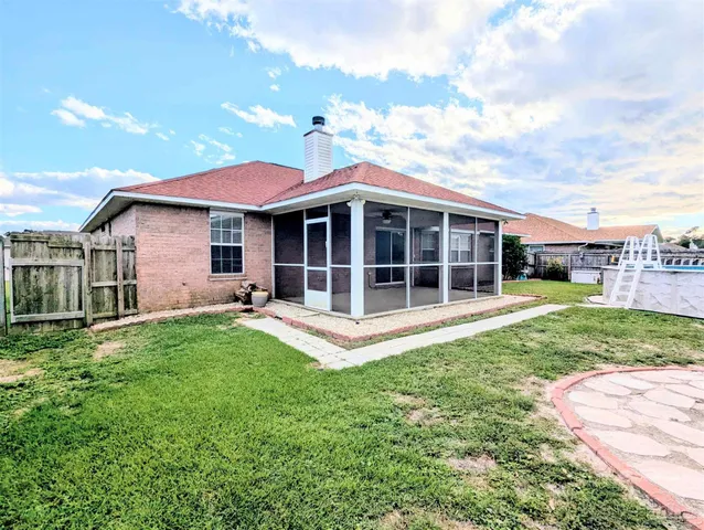 a view of a house with a backyard