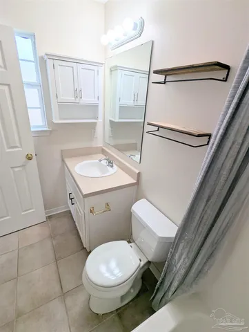 a white toilet sitting next to a bathroom sink
