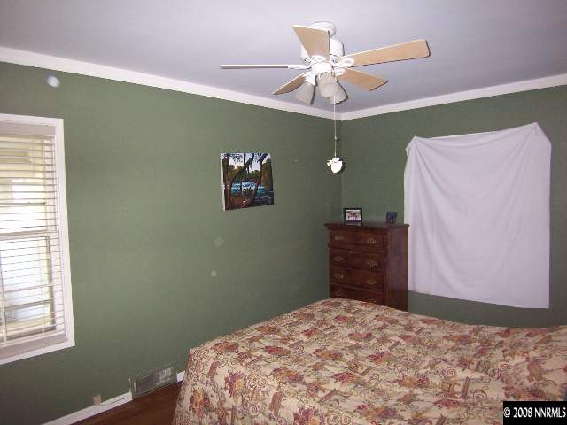 915 Primrose Street Reno, NV 89509 - Photo 6 of 9 a bedroom with a bed and a chandelier