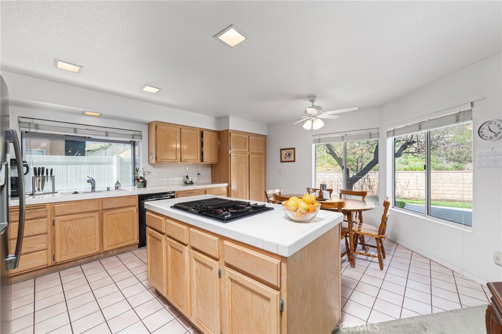 28962 Clear Spring Lane Highland, CA 92346 - Photo 11 of 32 a kitchen with a stove a sink a refrigerator and cabinets