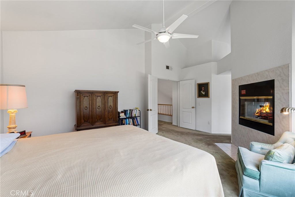 28962 Clear Spring Lane Highland, CA 92346 - Photo 13 of 32 a bedroom with a large bed and a chandelier