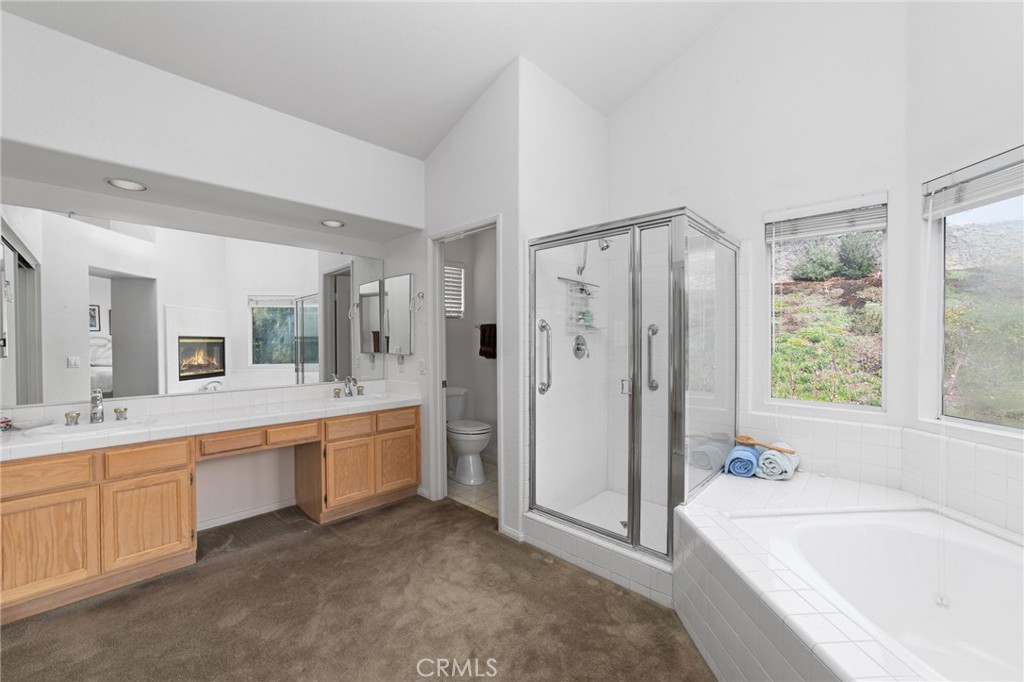 28962 Clear Spring Lane Highland, CA 92346 - Photo 15 of 32 a large bathroom with a tub sink shower and mirror