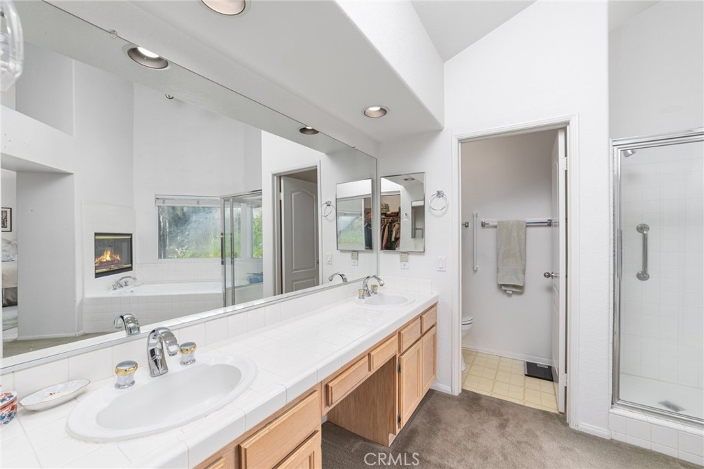 28962 Clear Spring Lane Highland, CA 92346 - Photo 16 of 32 a spacious bathroom with a double vanity sink mirror and shower
