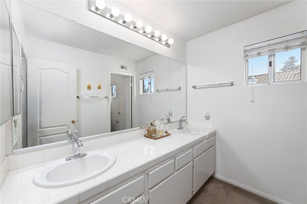28962 Clear Spring Lane Highland, CA 92346 - Photo 18 of 32 a bathroom with a sink and a mirror