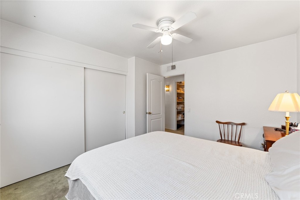 28962 Clear Spring Lane Highland, CA 92346 - Photo 23 of 32 a bedroom with a bed and a chandelier