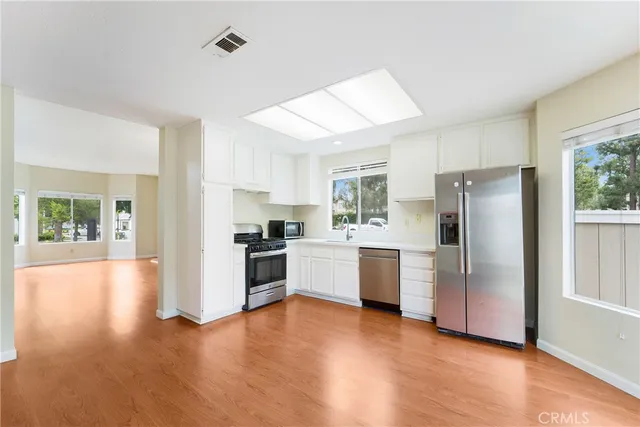 a kitchen with a refrigerator and a stove top oven