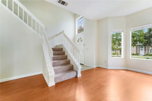 a view of an entryway with wooden floor