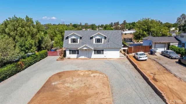 an aerial view of a house with yard swimming pool and outdoor seating
