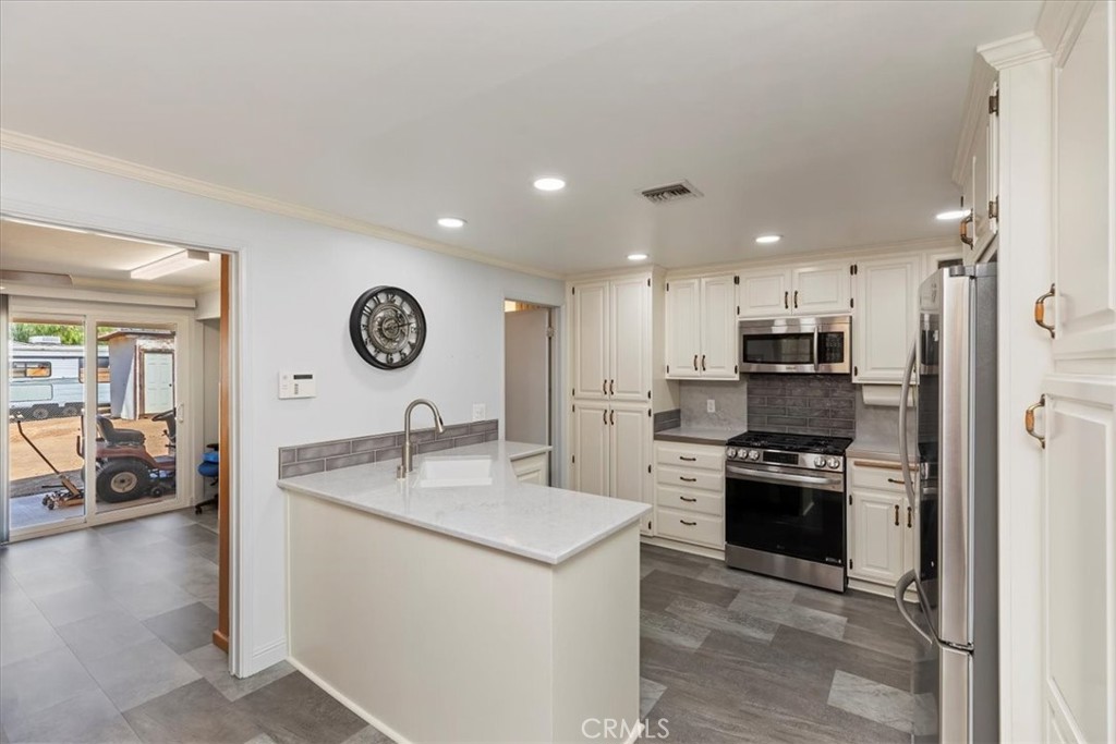 10555 Robinson Avenue Riverside, CA 92505 - Photo 26 of 65 a kitchen with stainless steel appliances granite countertop a sink stove and refrigerator