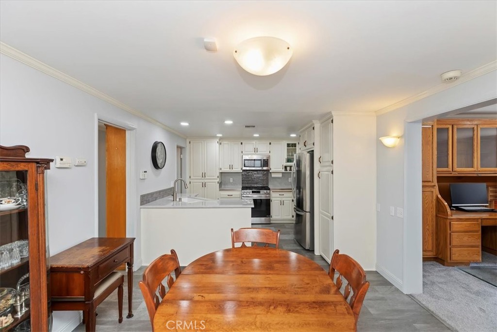 10555 Robinson Avenue Riverside, CA 92505 - Photo 30 of 65 a room with stainless steel appliances kitchen island granite countertop a refrigerator a stove and a dining table with wooden floor