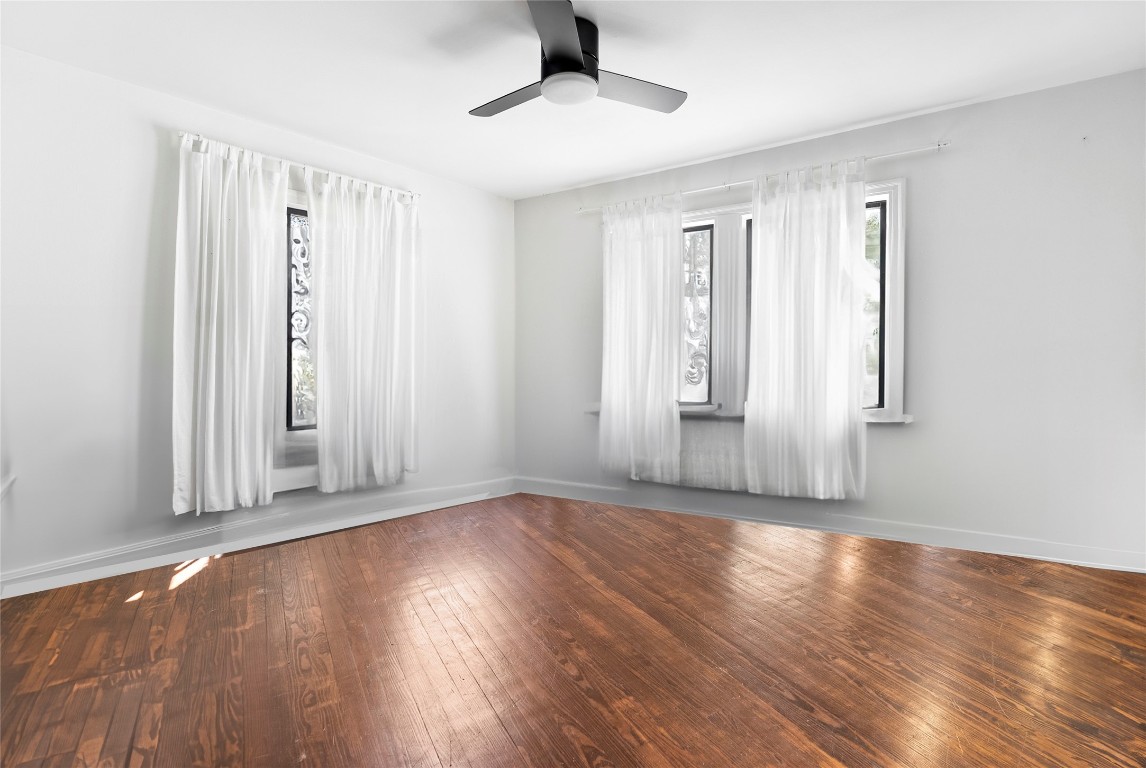 517 North Ave F Elgin, TX 78621 - Photo 12 of 21 a view of an empty room with wooden floor and a window
