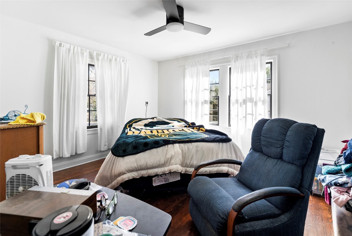 517 North Ave F Elgin, TX 78621 - Photo 13 of 21 a bedroom with a bed and wooden floor