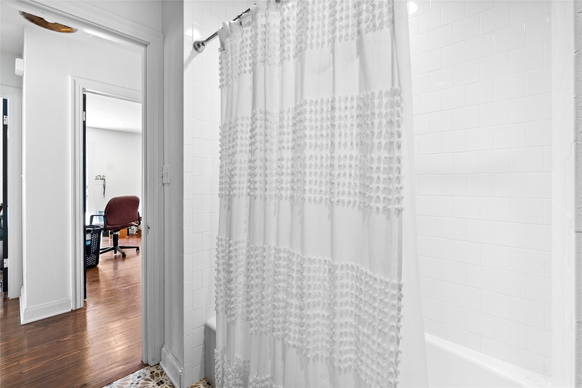 517 North Ave F Elgin, TX 78621 - Photo 15 of 21 a view of a bathroom with a shower curtain