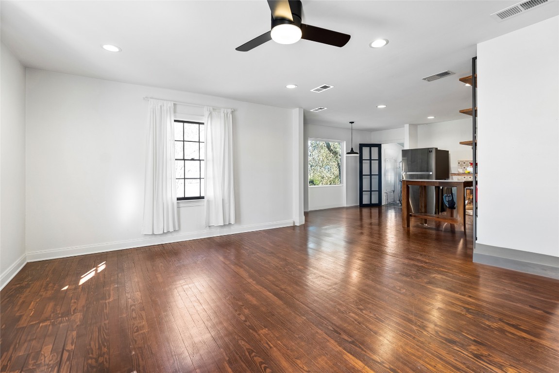 517 North Ave F Elgin, TX 78621 - Photo 6 of 21 an empty room with wooden floor and windows