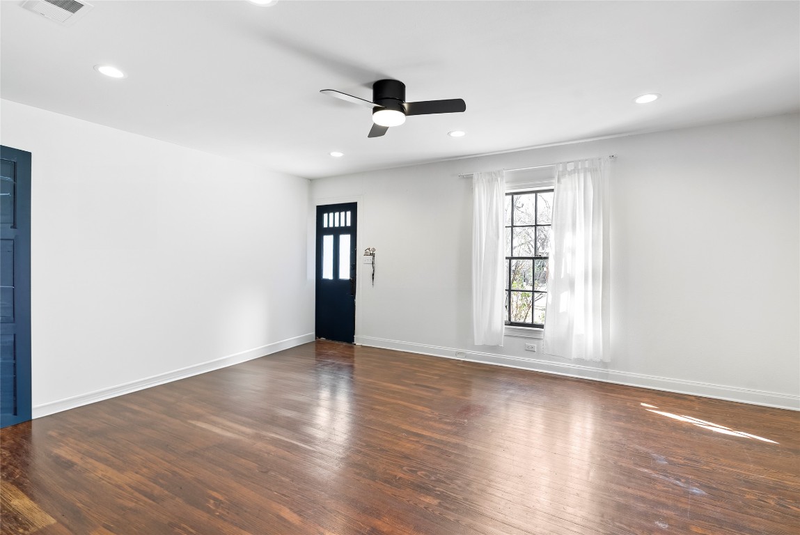 517 North Ave F Elgin, TX 78621 - Photo 7 of 21 an empty room with wooden floor and windows