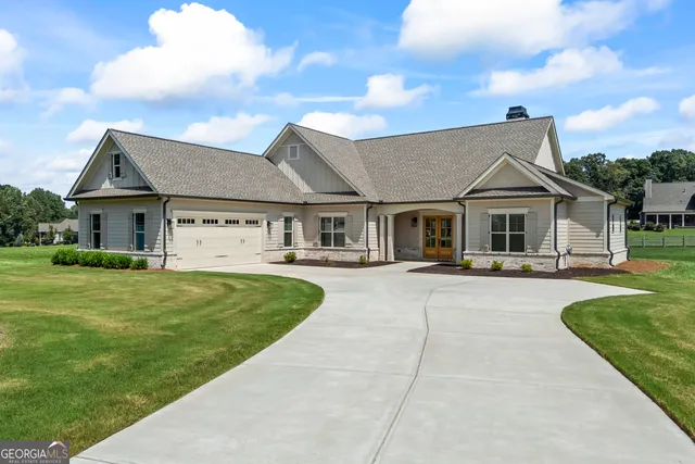 a front view of a house with a garden