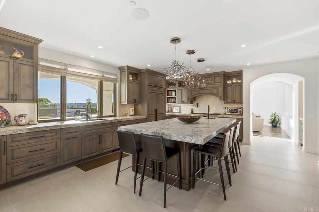 3226 Violet Ridge Encinitas, CA 92024 - Photo 14 of 54 a large kitchen with a table and chairs in it