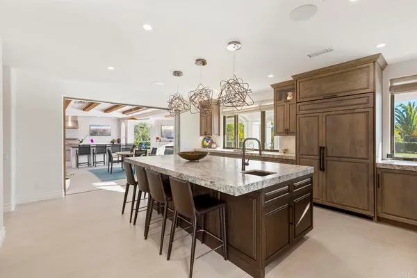 a kitchen with a stove a sink and a refrigerator