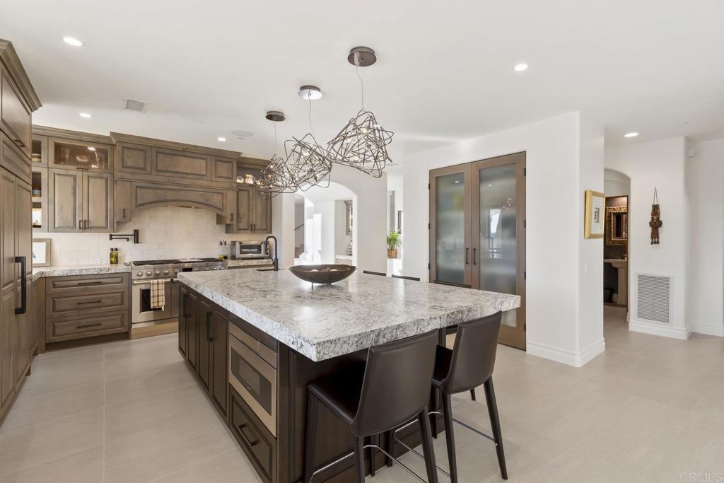 3226 Violet Ridge Encinitas, CA 92024 - Photo 16 of 54 a kitchen with a stove a sink and a refrigerator