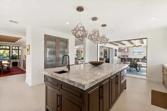 a kitchen with granite countertop cabinets stainless steel appliances and a sink