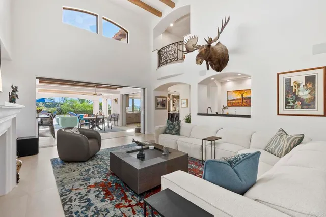 a living room with fireplace furniture and a floor to ceiling window