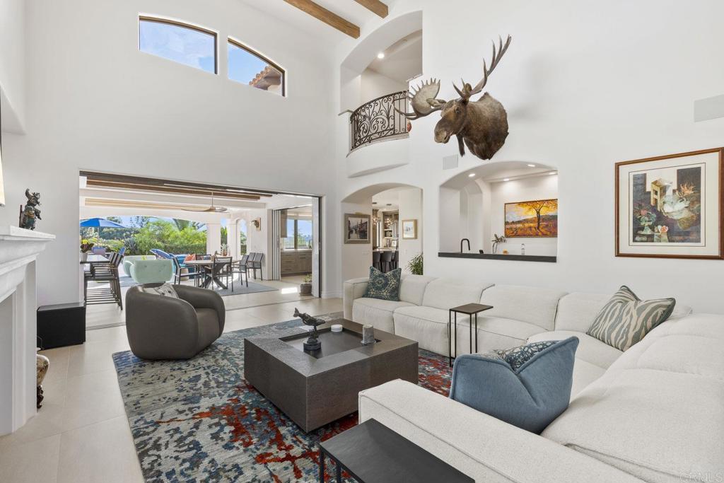 3226 Violet Ridge Encinitas, CA 92024 - Photo 20 of 54 a living room with furniture a rug and a floor to ceiling window