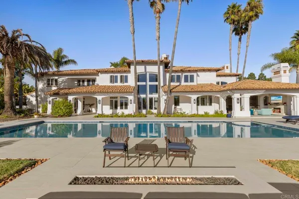 a front view of a house with a sitting area