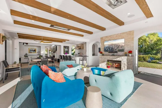 a dining room with furniture and a floor to ceiling window