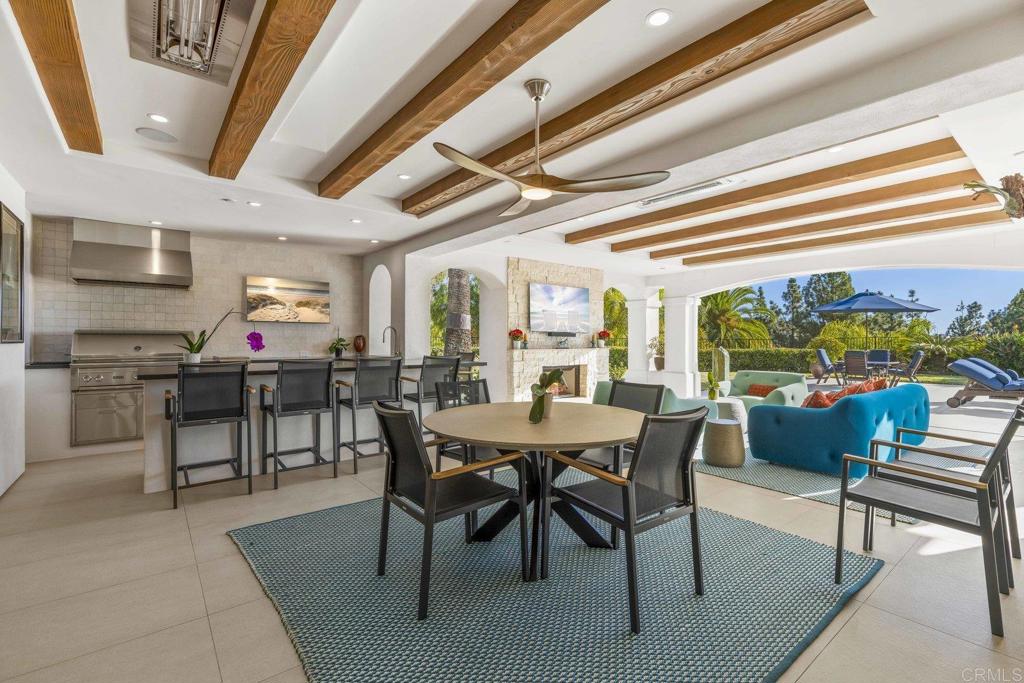 3226 Violet Ridge Encinitas, CA 92024 - Photo 24 of 54 a dining room with furniture and a floor to ceiling window