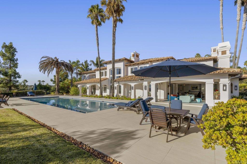 3226 Violet Ridge Encinitas, CA 92024 - Photo 25 of 54 a view of a patio with a table and chairs under an umbrella