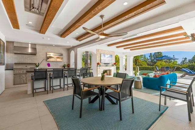 a view of a patio with a table and chairs under an umbrella