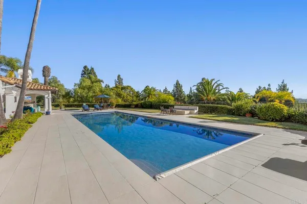 a view of a backyard with sitting area