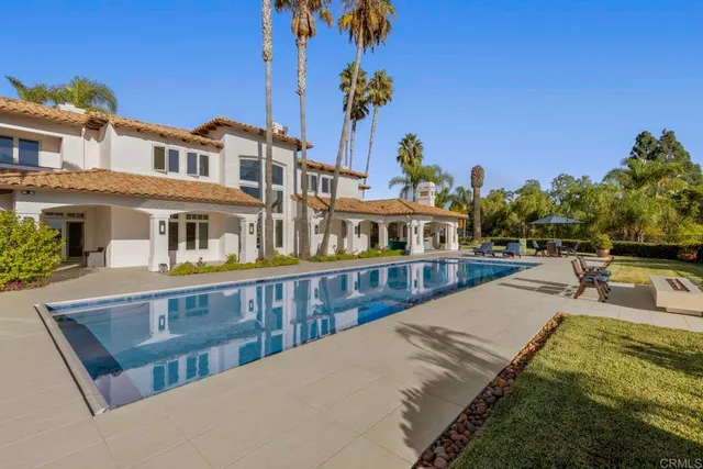 a view of swimming pool with outdoor seating and plants