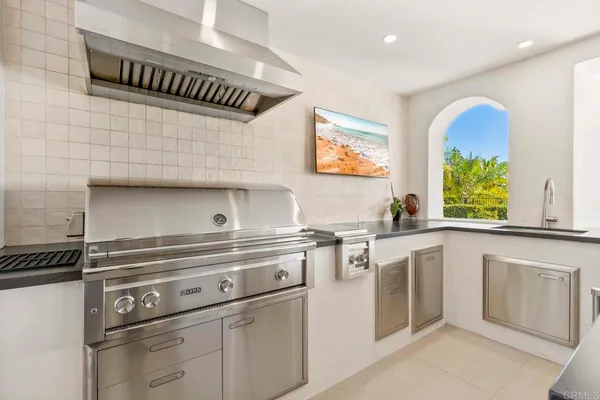 a kitchen with stainless steel appliances granite countertop a sink and a dishwasher next to a window