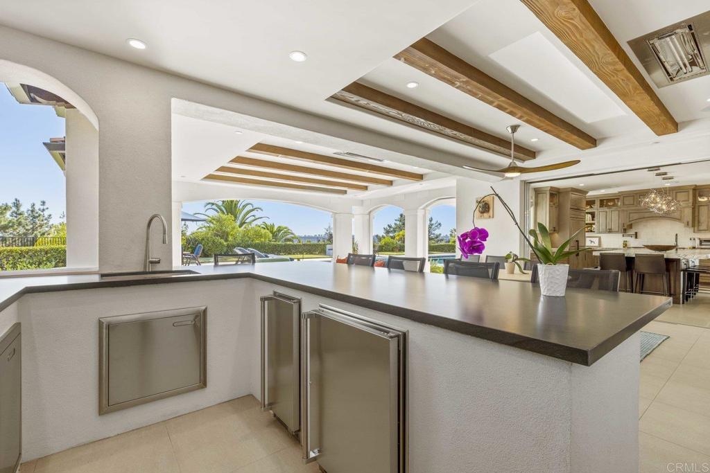 3226 Violet Ridge Encinitas, CA 92024 - Photo 32 of 54 a kitchen with stainless steel appliances granite countertop a sink and a dishwasher next to a window