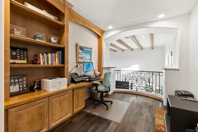 a spacious bedroom with a bed and a flat screen tv