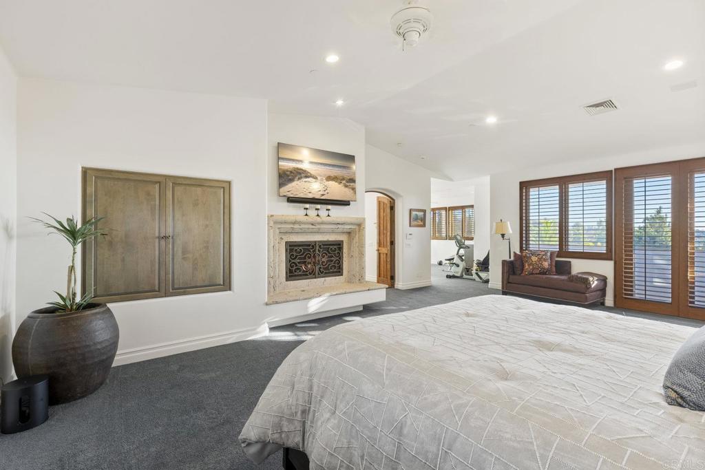 3226 Violet Ridge Encinitas, CA 92024 - Photo 41 of 54 a spacious bedroom with a bed and a chandelier