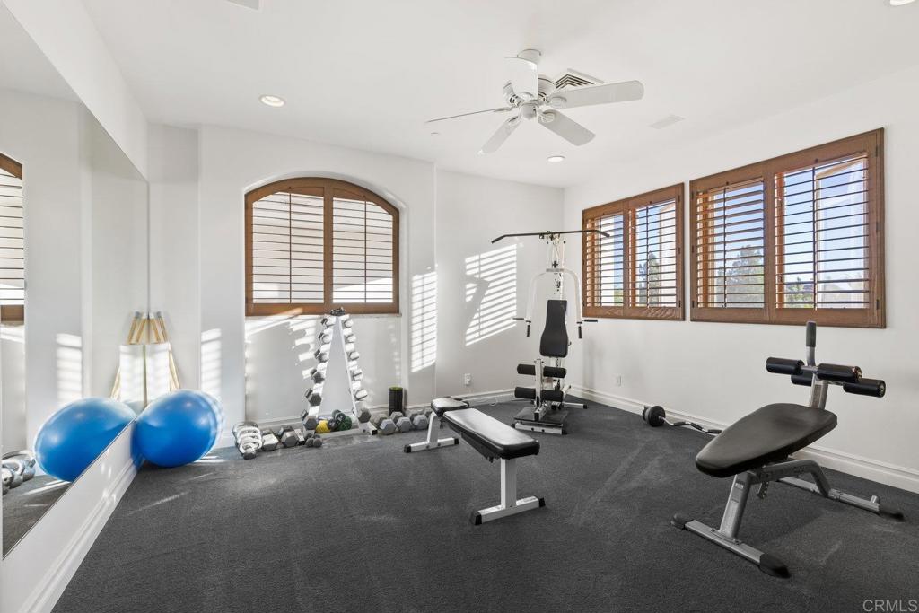 3226 Violet Ridge Encinitas, CA 92024 - Photo 42 of 54 a room with gym equipment and windows